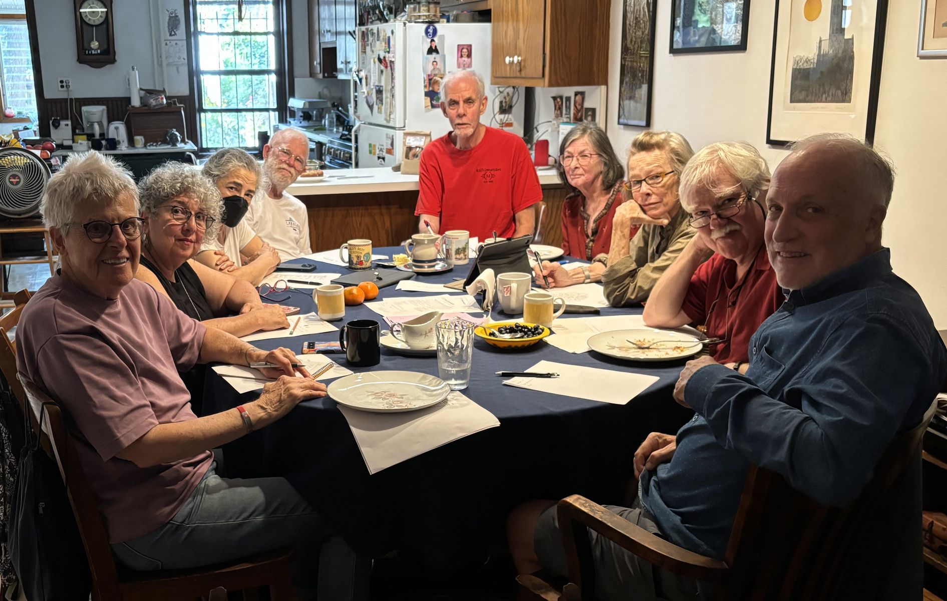 Choir members gathered around a dinner table